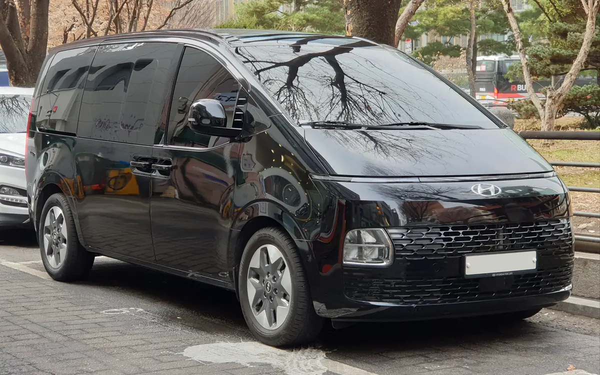 A black Hyundai Staria people mover, seen from the front three-quarter